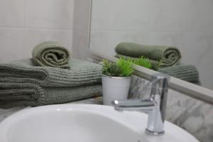 a bathroom with a sink and a mirror and towels at Vista Bonita - Beautiful View!!! in Santa Pola +25 photos