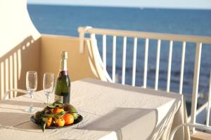 a bottle of wine and glasses on a table with a plate of fruit at Vista Bonita - Beautiful View!!! in Santa Pola