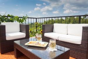 a patio with two chairs and a table with a tray of food at Finca Hotel Los Girasoles in Montenegro