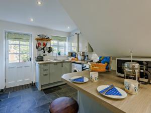 a kitchen with a counter and a stove top oven at 1 bed property in Instow 55340 in Instow