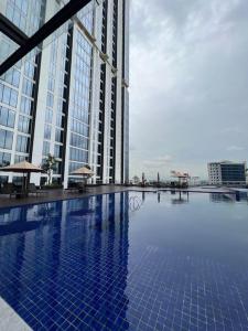 una gran piscina frente a un edificio alto en Wawa Guesthouse Pollux Habibie Batam Tower A 18, en Batam Centre