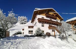 a building with snow on the ground in front of it at Haus Illmer - Fiss in Fiss