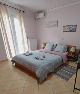 a bedroom with a large bed with towels on it at Elpida's house in Spata