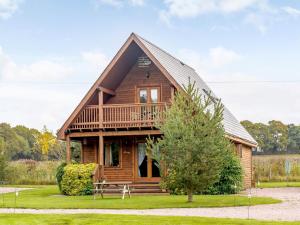 a log cabin with a porch and a deck at 3 Bed in Ledbury 77379 