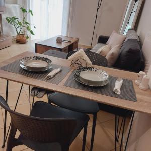 a living room with a table and a couch at Elpida's house in Spata