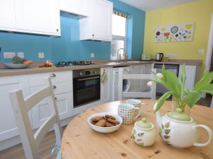 a kitchen with a wooden table with a bowl of food on it at 3 bed in Eastbourne EHC04 in Eastbourne