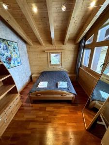 a bedroom in a log cabin with a bed in it at Grand chalet au centre in Anzère