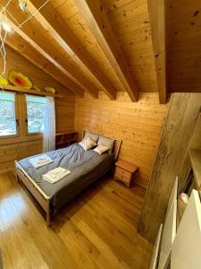 a bedroom with a bed in a log cabin at Grand chalet au centre in Anzère