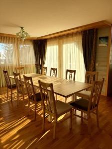 a dining room with a wooden table and chairs at Grand chalet au centre in Anzère