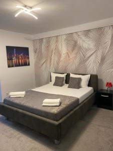 a bedroom with a bed with two towels on it at ANS House in Deva