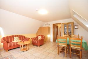 a living room with two chairs and a table at J. Apfeld Ferienwohnungen in Borkum