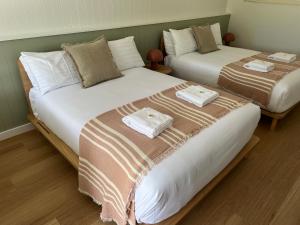 two beds sitting next to each other in a room at The Edgewater at Burrill in Ulladulla