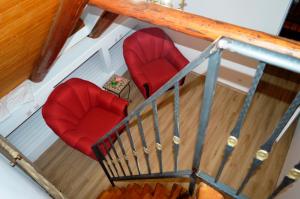 an overhead view of two red chairs on a staircase at Casa cu Magnolii in Poienile Izei