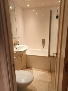 a bathroom with a sink and a toilet and a tub at Chelsea in London