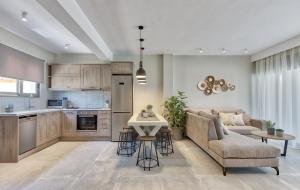 a kitchen and living room with a couch and a table at Sabbia D`oro Beach Villa in Meson Yerakarion