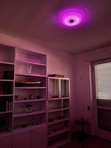 a living room with a purple light on the ceiling at Appartamento Sarteano in Sarteano