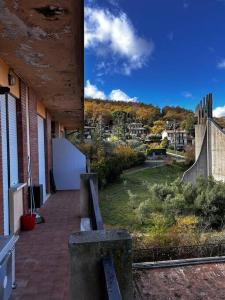 a building with a brick walkway next to a yard at Appartamento Sarteano in Sarteano