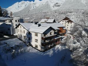 an aerial view of a building in the snow at Landhaus Zangerl - Kobelerhof in Landeck