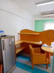 a room with a desk and a table and a refrigerator at Bella B PLUS เบลล่า บี พลัส in Bangkok