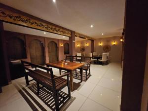 a dining room with a wooden table and chairs at Khamma Heritage in Jodhpur