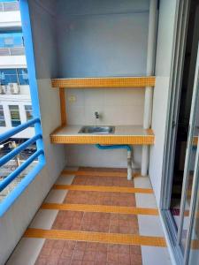 a bathroom with a sink in a room at Mansion Sarasinee @ Chatuchak in Bangkok