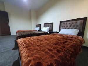 two beds in a hotel room with two beds at Petraone in Wadi Musa