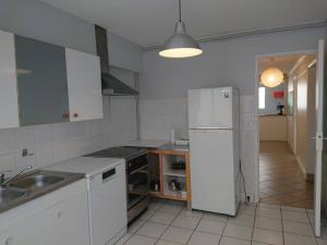 a kitchen with a white refrigerator and a sink at Chambre dans colocation aux Chartrons in Bordeaux