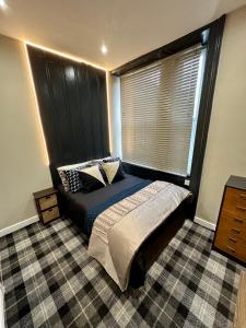 a bedroom with a bed and a large window at Botanica @ The.Villas.Newcastle in Elswick