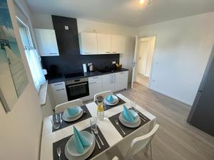a kitchen and dining room with a table and chairs at Modern Flat with Garden & Terrace near Coburg in Ebersdorf bei Coburg