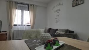 a living room with a table with two cakes on it at APARTMAN ANDREA in Leskovac