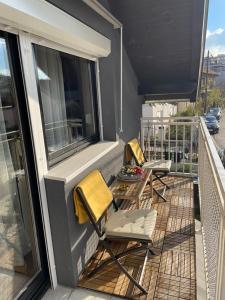 two chairs and a table on a balcony at Roba's Apartment in Zagreb