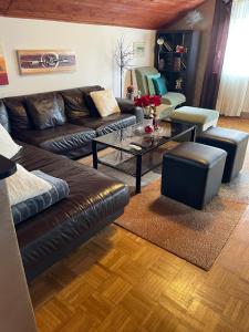 a living room with a leather couch and a table at Roba's Apartment in Zagreb