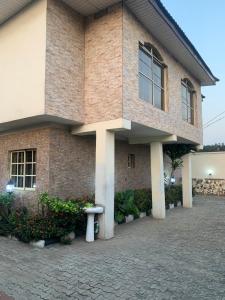a brick building with a bench in front of it at Tivoli Residence & Hotels in Lagos