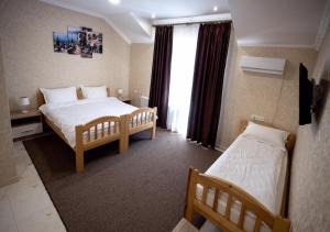a hotel room with two beds and a window at Готель River House in Uman +85 photos
