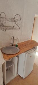a bathroom with a sink with a wooden counter top at Cuevas Althea in Baza