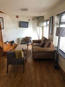 a living room with a couch and a table at The Loft, Ardfert in Ard Fhearta