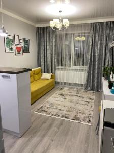 Et opholdsområde på Уютные апартаменты в ЖК Millenium park