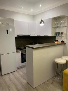 Køkken eller tekøkken på Уютные апартаменты в ЖК Millenium park