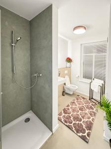 a bathroom with a shower and a toilet at Modern living: Hamburg & Baltic Sea within 30 min in Ahrensburg