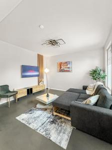 a living room with a couch and a flat screen tv at Modern living: Hamburg & Baltic Sea within 30 min in Ahrensburg