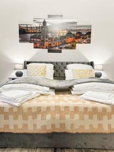 two beds in a bedroom with two paintings on the wall at Modern living: Hamburg & Baltic Sea within 30 min in Ahrensburg