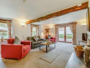 a living room with two couches and a table at 2 Bed in Woolacombe 28803 in Bittadon