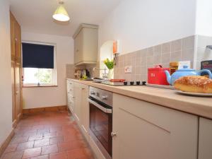 a kitchen with a counter top with a stove top oven at 2 bed in Binham 26324 in Binham
