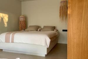 a bedroom with a white bed with two pillows at Apartamento en Salinas in Ses Salines