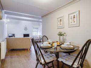 a dining room with a table and chairs and a living room at 1 bed in Cullen 43628 in Cullen