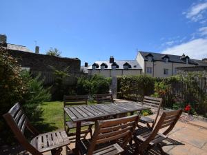 a wooden picnic table and chairs in a garden at 3 bed property in Watchet OLDMW in Watchet