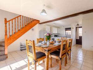 a kitchen and dining room with a wooden table and chairs at 3 bed in Brean WINDC in Berrow