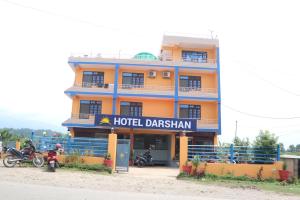 un edificio de hotel con motocicletas estacionadas frente a él en Hotel Darshan, en Surkhet