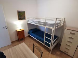 ein Schlafzimmer mit einem Etagenbett und einem blauen Sofa in der Unterkunft Casetta Nociarelle in Piegaro