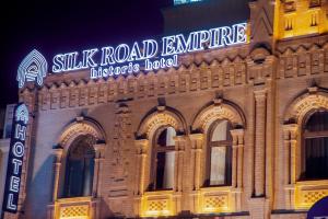 a building with a sign on the side of it at HOTEL SILK ROAD EMPIRE SAMARKAND in Samarkand
